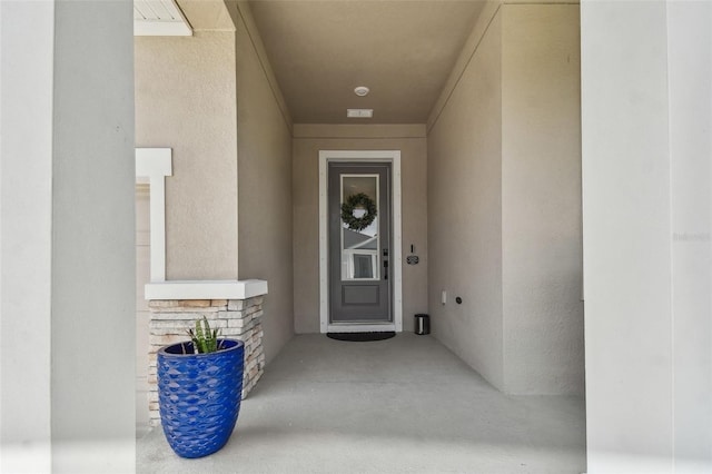 view of exterior entry featuring stone siding