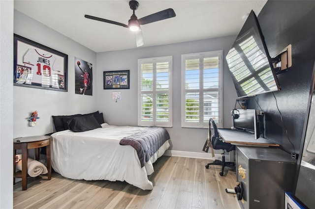 bedroom featuring baseboards, ceiling fan, and light wood-style flooring