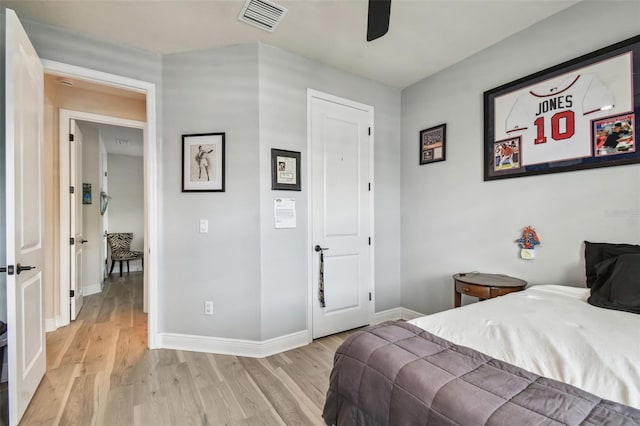bedroom with visible vents, a ceiling fan, light wood-style floors, and baseboards