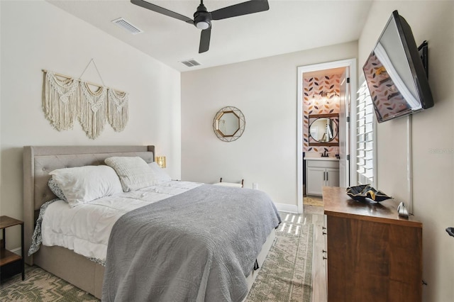 bedroom with visible vents, a ceiling fan, connected bathroom, and baseboards