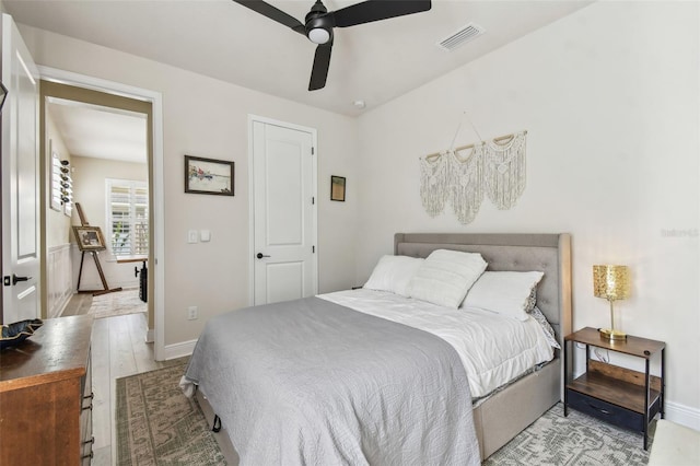 bedroom with baseboards, a ceiling fan, and visible vents