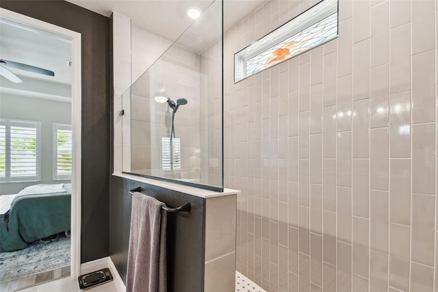 bathroom with ceiling fan, walk in shower, and ensuite bathroom
