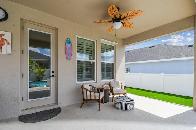 view of patio with fence and ceiling fan