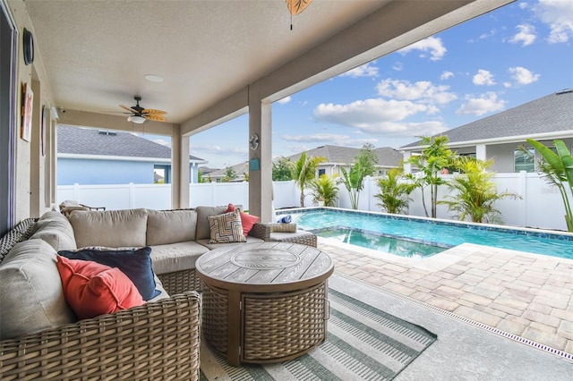 view of pool with ceiling fan, an outdoor living space, a fenced backyard, and a fenced in pool