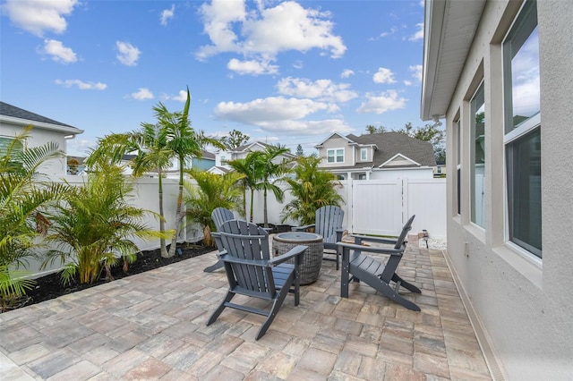 view of patio / terrace with a fenced backyard, a fire pit, and a residential view