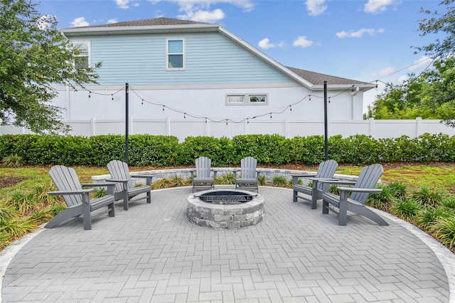 view of patio / terrace with fence and a fire pit