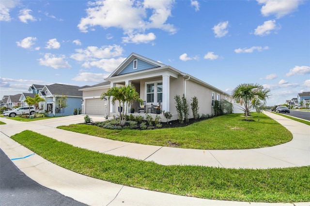 ranch-style home with an attached garage, a front lawn, stucco siding, covered porch, and driveway
