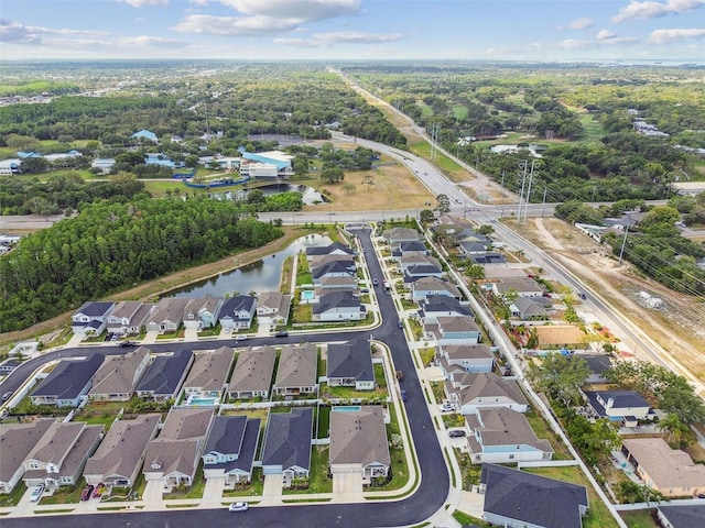 birds eye view of property with a water view and a residential view