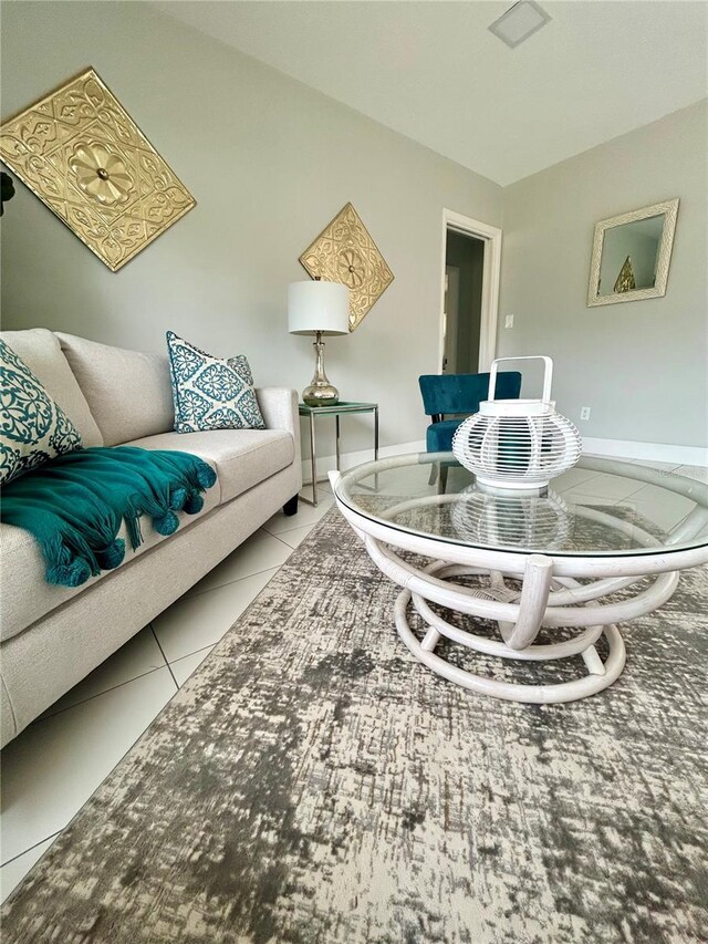 living room with baseboards and tile patterned floors