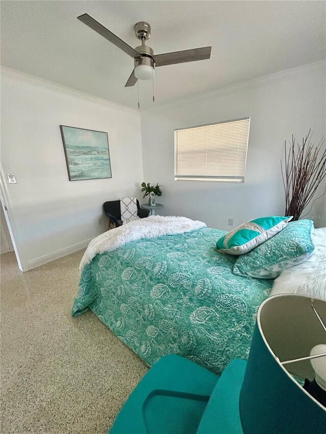 bedroom with baseboards, ornamental molding, and ceiling fan