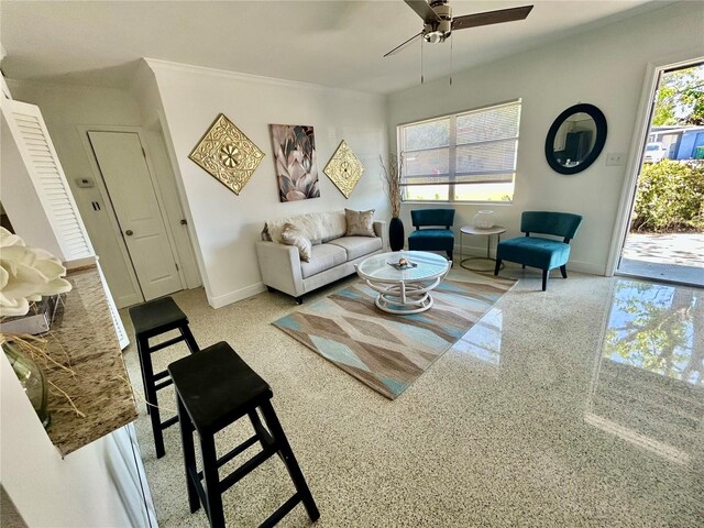 living room featuring baseboards and a ceiling fan