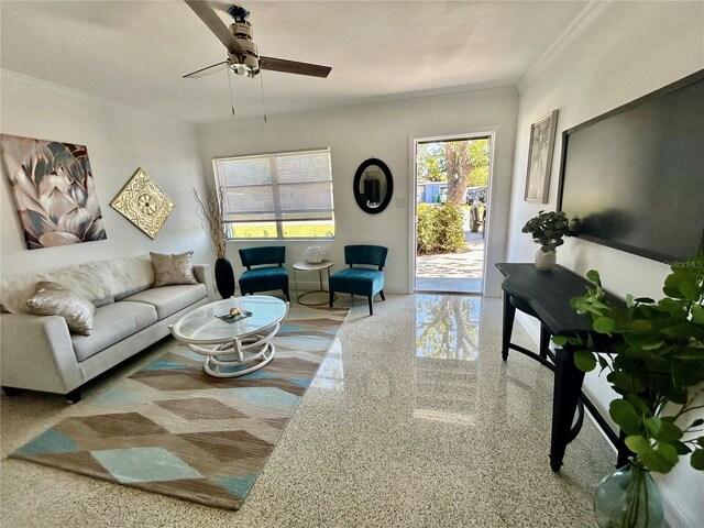 carpeted living room with plenty of natural light, baseboards, crown molding, and ceiling fan
