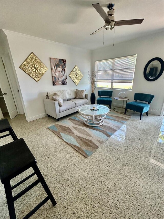living room featuring baseboards and ceiling fan
