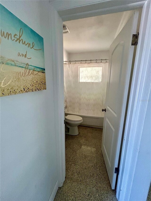 full bathroom featuring baseboards, toilet, and a shower with curtain