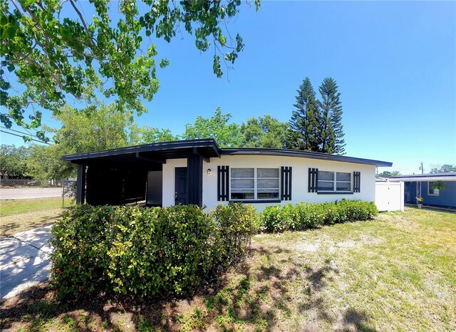 ranch-style house featuring stucco siding and a front lawn