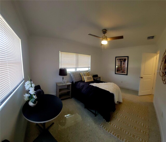bedroom with a ceiling fan, baseboards, visible vents, and carpet