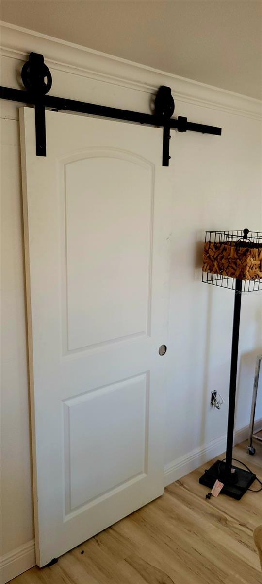 room details with baseboards, crown molding, and wood finished floors