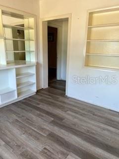 spare room featuring wood finished floors