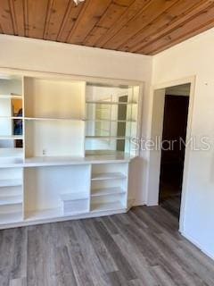 unfurnished bedroom with wood ceiling and wood finished floors