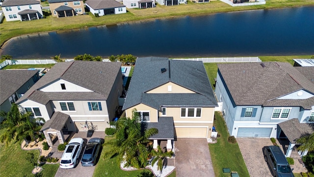 bird's eye view featuring a water view and a residential view