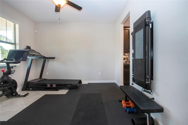 workout area featuring baseboards and ceiling fan