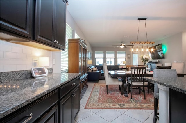 dining space with ceiling fan and light tile patterned floors