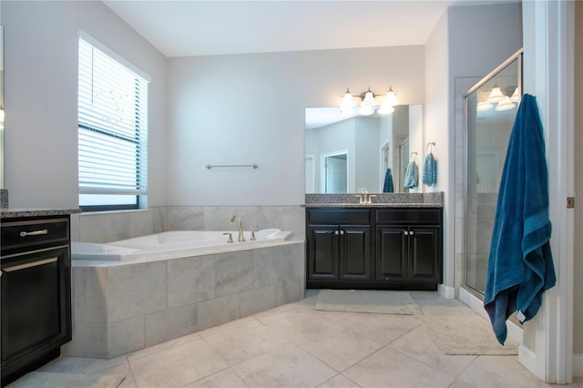 bathroom featuring vanity, tile patterned floors, a garden tub, and a stall shower