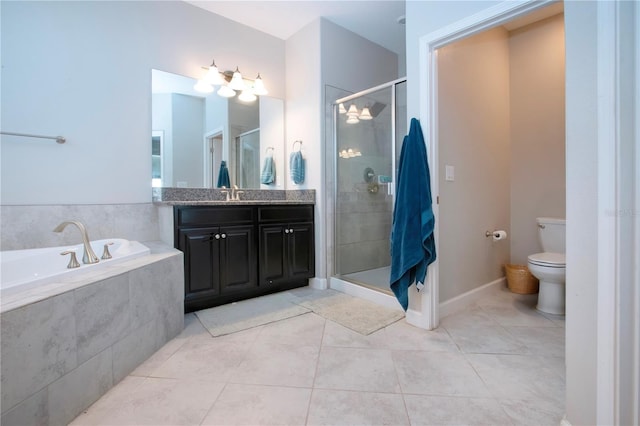 bathroom with vanity, toilet, tile patterned floors, a shower stall, and a bath
