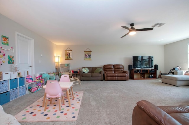 living room with visible vents, a ceiling fan, and carpet