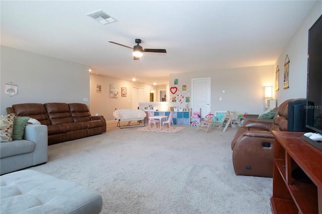 living room with carpet floors, a ceiling fan, and visible vents