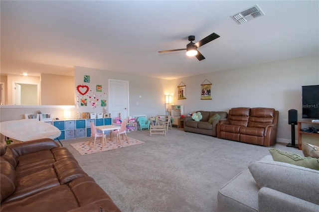carpeted living room featuring ceiling fan and visible vents