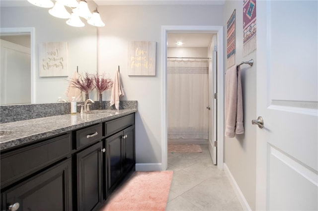 bathroom featuring vanity, an inviting chandelier, baseboards, tile patterned floors, and a shower with curtain