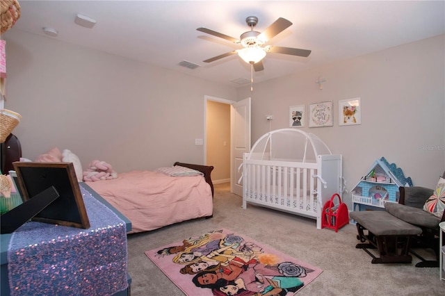 carpeted bedroom featuring visible vents and a ceiling fan