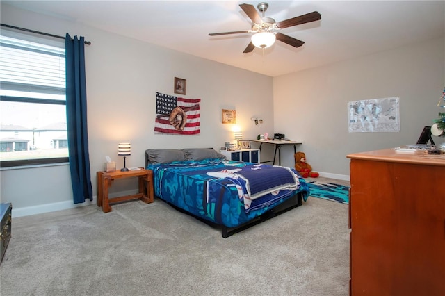 carpeted bedroom with baseboards and a ceiling fan
