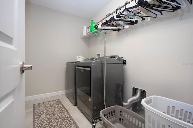 laundry area with laundry area, light tile patterned flooring, and independent washer and dryer