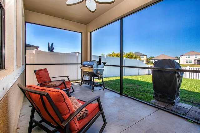 sunroom featuring concrete flooring and ceiling fan