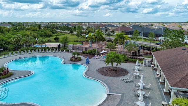community pool featuring fence and a patio area