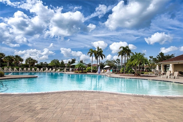 community pool featuring a patio and fence
