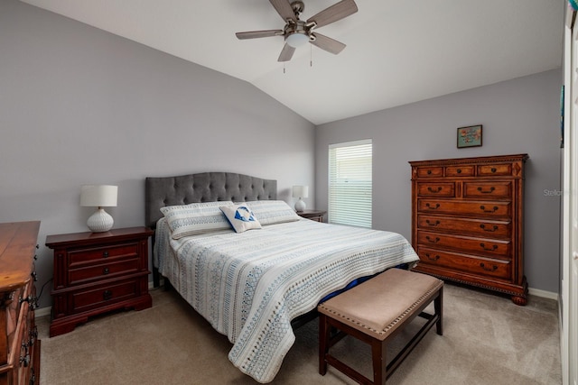 bedroom with baseboards, ceiling fan, vaulted ceiling, and light carpet