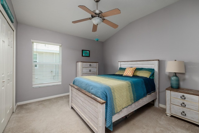bedroom with baseboards, light colored carpet, and a closet