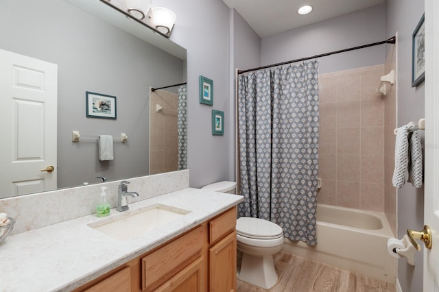bathroom with vanity, wood finished floors, toilet, and shower / bath combo with shower curtain