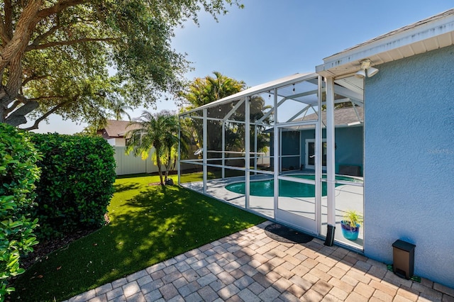 pool featuring a fenced backyard, a yard, and a patio area
