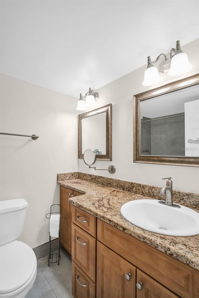 4725 Cove Cir Unit 601, Saint Petersburg, FL 33708 - bathroom featuring toilet, tile patterned floors, vanity, and baseboards