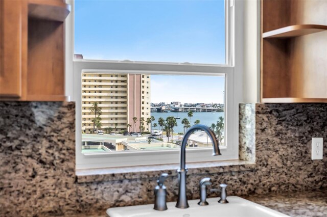 4725 Cove Cir Unit 601, Saint Petersburg, FL 33708 - kitchen view of backsplash, a sink, and a water view