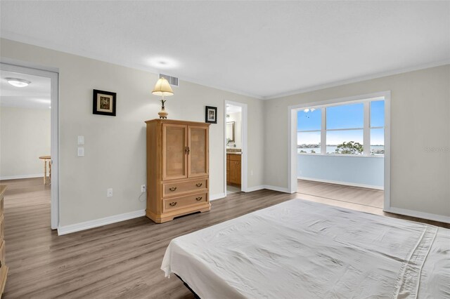 4725 Cove Cir Unit 601, Saint Petersburg, FL 33708 - bedroom featuring wood finished floors and baseboards