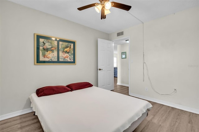 4725 Cove Cir Unit 601, Saint Petersburg, FL 33708 - bedroom with wood finished floors, baseboards, and a ceiling fan