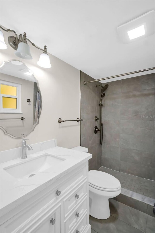 4725 Cove Cir Unit 601, Saint Petersburg, FL 33708 - full bathroom with tiled shower, toilet, vanity, and tile patterned floors