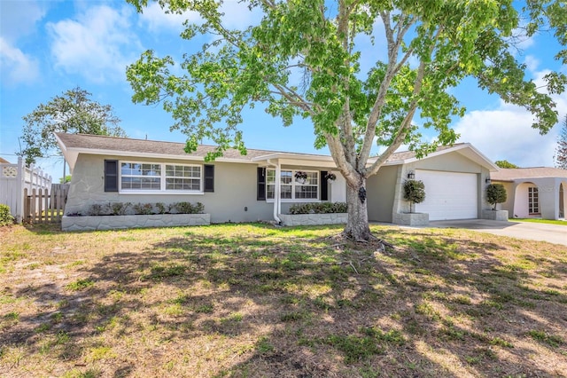 single story home featuring stucco siding, fence, driveway, and a garage