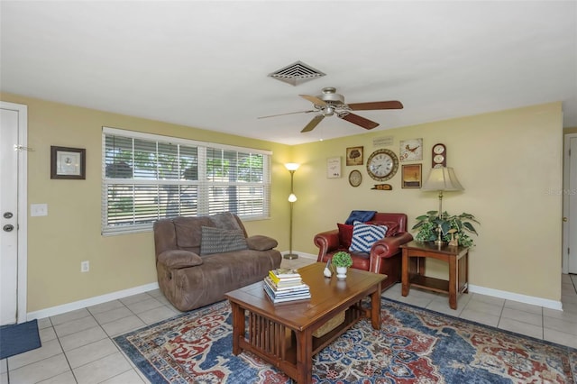 living room featuring light tile patterned floors, baseboards, ceiling fan, and visible vents