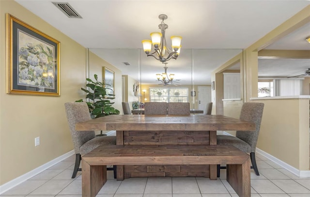 dining space featuring an inviting chandelier, light tile patterned floors, baseboards, and visible vents